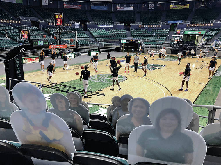 GEORGE F. LEE / GLEE@STARADVERTISER.COM 
                                The University of Hawaii basketball team warmed up in front of cardboard cutouts prior to its game against Hawaii-Hilo on Dec. 19 at the renamed SimpliFi Arena. Fans have not been able to attend UH events since the pandemic shut down sports in March.