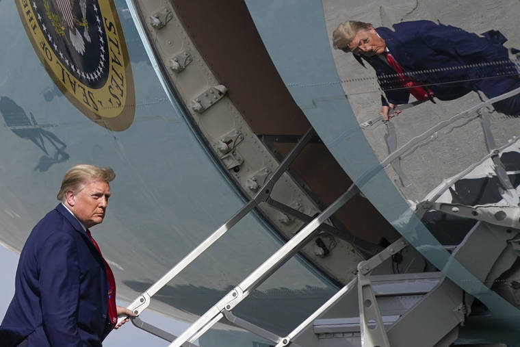 ASSOCIATED PRESS
                                President Donald Trump boards Air Force One at Palm Beach International Airport, Thursday in West Palm Beach, Fla.