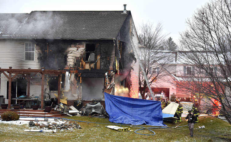 ASSOCIATED PRESS
                                First responders investigate the scene of a plane that crashed into a house, setting it on fire in Lyon Township, Michigan Saturday night.