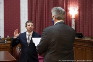 WEST VIRGINIA LEGISLATURE VIA AP
                                West Virginia House of Delegates member Derrick Evans, left, is given the oath of office on Dec. 14 in the House chamber at the state Capitol in Charleston, W.Va.