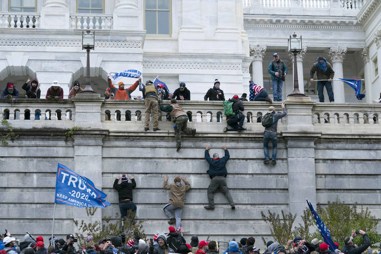 ASSOCIATED PRESS
                                Supporters of President Donald Trump climbed the west wall of the U.S. Capitol, Wednesday, in Washington.