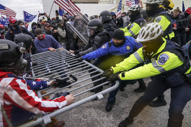 ASSOCIATED PRESS
                                Trump supporters tried to break through a police barrier, Wednesday, at the Capitol in Washington.