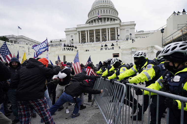 ASSOCIATED PRESS
                                Trump supporters try to broke through a police barrier, Wednesday, at the Capitol in Washington.