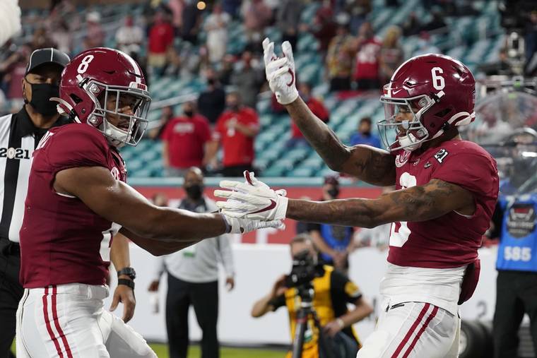ASSOCIATED PRESS
                                Alabama wide receiver John Metchie III, left, congratulates wide receiver DeVonta Smith, after Smith scored a touchdown against Ohio State during the first half of an NCAA College Football Playoff national championship game, Monday, in Miami Gardens, Fla.
