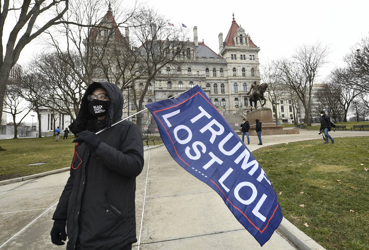 ASSOCIATED PRESS
                                Christina Janowitz of Guilderland, N.Y., from the group “All Of Us’ holds a flag while counter-protesting a Trump rally ahead of the inauguration of President-elect Joe Biden and Vice President-elect Kamala Harris at the New York State Capitol today in Albany, N.Y.
