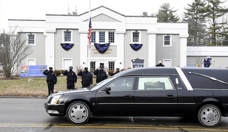 Mark Stockwell/The Sun Chronicle via ASSOCIATED PRESS
                                Norton, Mass. police saluted as a hearse carrying colleague Det. Sgt. Stephen Desfosses briefly stopped in front of the police station on Thursday. Desfosses, 52, a local police officer for 32 years, died of the coronavirus Wednesday in Boston with members of his family by his side, Police Chief Brian Clark said in a statement.