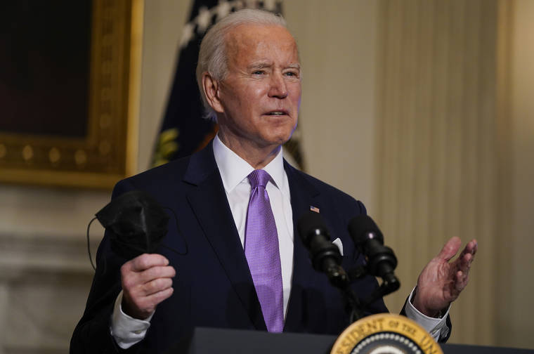 ASSOCIATED PRESS
                                President Joe Biden holds his face mask as he delivers remarks on COVID-19 today at the White House.
