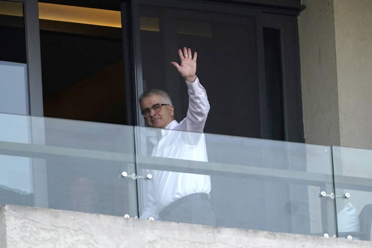 ASSOCIATED PRESS
                                Dominic Dwyer of the World Health Organization team waves at journalists from a hotel room balcony in Wuhan in central China’s Hubei province on Friday.