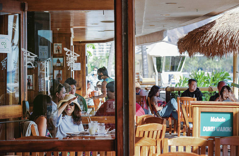 STAR-ADVERTISER / AUG. 25
                                Hawaii’s chief economist, Eugene Tian, said the second half of 2021 should be better for the economy — when vaccines become widely available. Diners sit outdoors at Duke’s Waikiki beachfront restaurant.