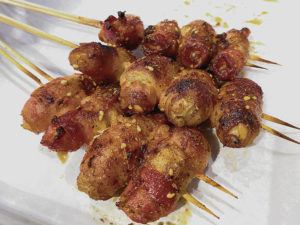 NADINE KAM / SPECIAL TO THE STAR-ADVERTISER
                                Bacon-wrapped enoki is among items on a lengthy menu at Volcano Skewer House.