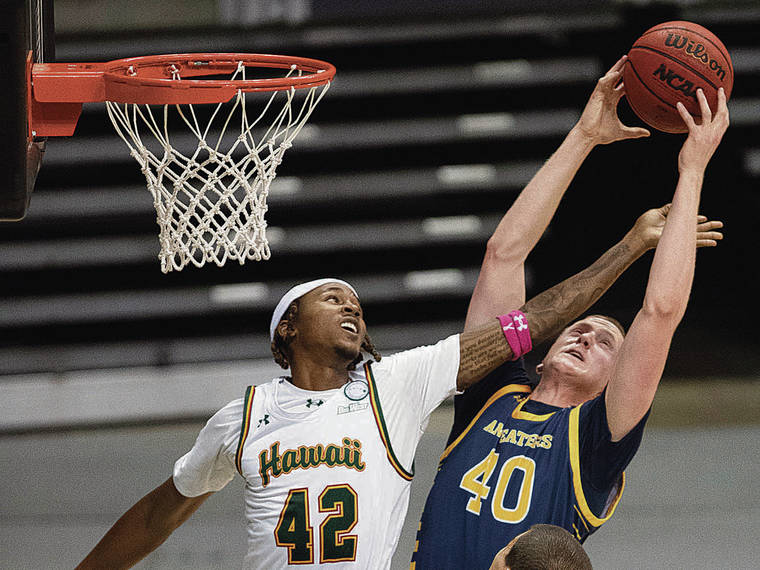 GEORGE F. LEE / GLEE@STARADVERTISER.COM Hawaii’s Justin Hemsley fought for a rebound against UC Irvine’s Collin Welp on Friday.