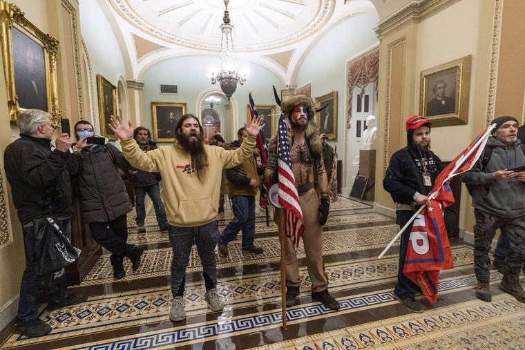 ASSOCIATED PRESS
                                Supporters of President Donald Trump are confronted by U.S. Capitol Police officers outside the Senate Chamber inside the Capitol.