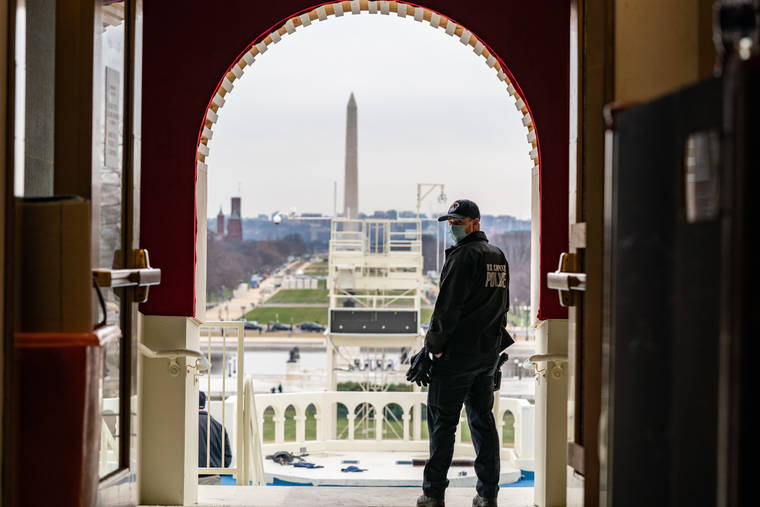 NEW YORK TIMES
                                A U.S. Capitol Police officer stands in an archway leading to the inaugural stage at the Capitol on Monday.