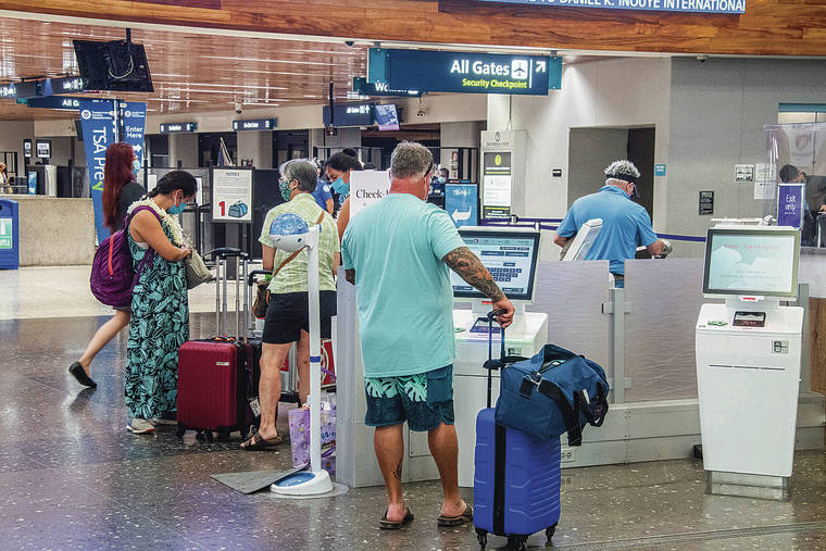 CRAIG T. KOJIMA / CKOJIMA@STARADVERTISER.COM 
                                Travelers got their tickets at kiosks at Hawaiian Airlines terminal on Friday.