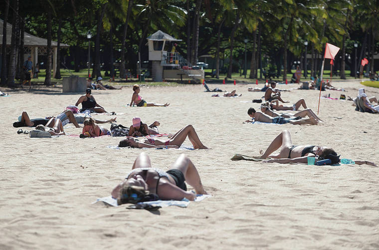 CINDY ELLEN RUSSELL / CRUSSELL@STARADVERTISER.COM
                                The latest surge in COVID-19 infections is due to recent social gatherings. Above, beachgoers soaked up the sun Thursday at Queen’s Surf Beach in Waikiki.