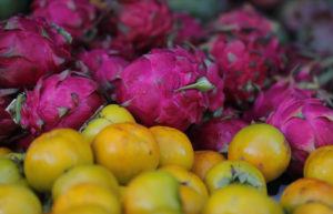 JAMM AQUINO / JAQUINO@STARADVERTISER.COM
                                Dragonfruits and persimmons are seen at Saturday’s market at Kapiolani Community College.