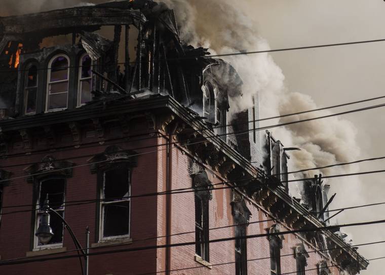 ASSOCIATED PRESS
                                Crews battle a four-alarm fire on East Carson Street in Pittsburgh, Pa., today. The blaze reported at about 2:30 p.m. sent flames and smoke poured from the building. At one point, the side of the building facing 11th street collapsed.