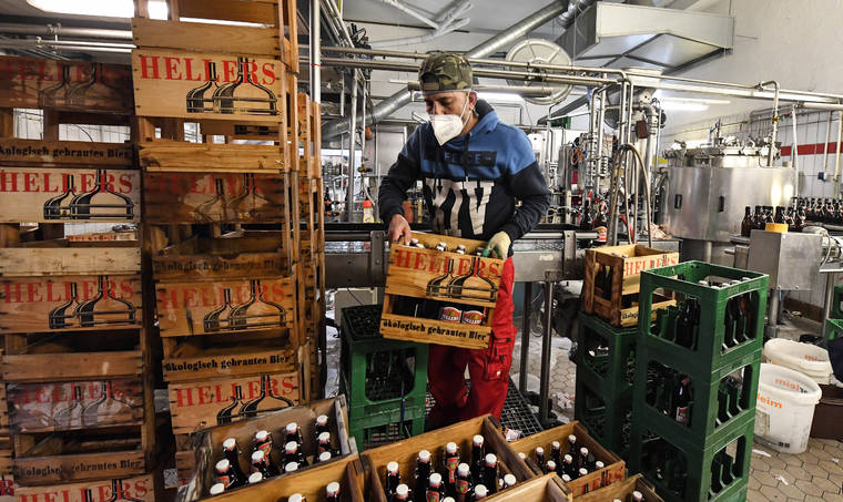 ASSOCIATED PRESS
                                Employees work in the small family-run Heller brewery in Cologne, Germany, Tuesday.