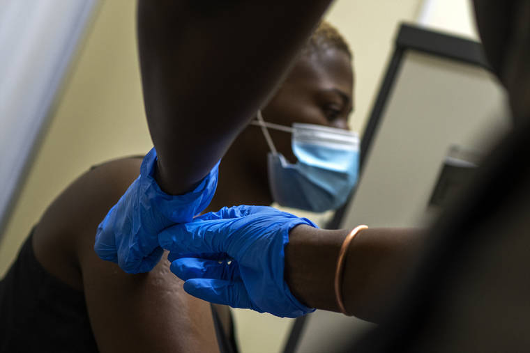ASSOCIATED PRESS
                                Thabisle Khlatshwayo, who received her first shot for a COVID-19 vaccine trial, received her second AstraZeneca shot, Nov. 30, at a vaccine trial facility set at Soweto’s Chris Sani Baragwanath Hospital outside Johannesburg, South Africa.
