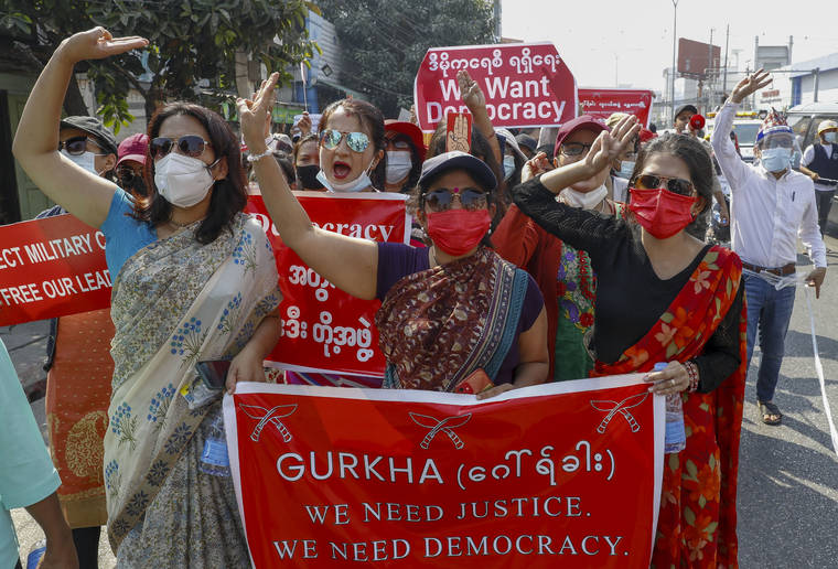 ASSOCIATED PRESS
                                Demonstrators with placards shout slogans against the military coup during a protest in Mandalay, Myanmar on Thursday.