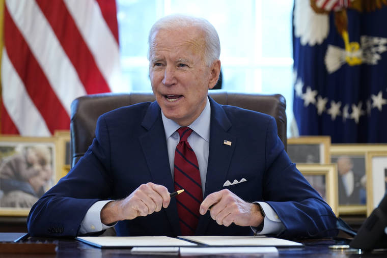 ASSOCIATED PRESS / JAN. 28
                                President Joe Biden signs a series of executive orders in the Oval Office of the White House in Washington last month. Biden campaigned on raising the national minimum wage to $15 an hour and attached a proposal doing just that to the $1.9 trillion coronavirus pandemic relief bill.
