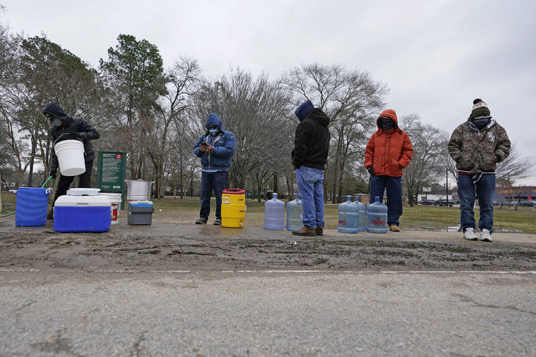 ASSOCIATED PRESS
                                People waited in near-freezing temperatures to fill water bottles and coolers with water from a public park spigot, today, in Houston. Houston and several surrounding cities are under a boil water notice as many residents are still without running water in their homes.