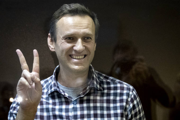 ASSOCIATED PRESS
                                Russian opposition leader Alexei Navalny gestures as he stands behind a grass of the cage in the Babuskinsky District Court in Moscow, Russia. A Moscow court has rejected Russian opposition leader Alexei Navalny’s appeal against his prison sentence. Earlier this month, a lower court sentenced Navalny to two years and eight months in prison for violating terms of his probation while recuperating in Germany from a nerve agent poisoning that he blames on the Kremlin.