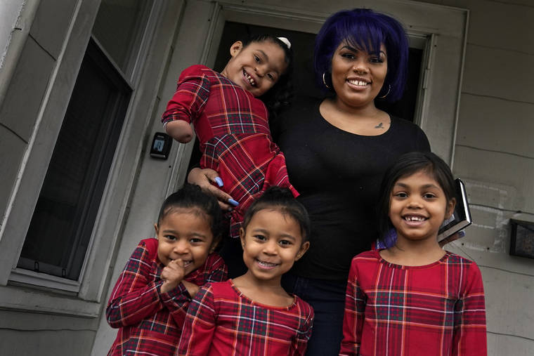 ASSOCIATED PRESS
                                Dinora Torres, a MassBay Community College student, poses with her four daughters on the front porch of their home in Milford, Mass. From front left are daughters Davina, Alana and Hope, with Faith in Dinora’s arms. At the college, applications for meal assistance scholarships have increased 80% since last year. Among the recipients is Torres, who said the program helped keep her enrolled.