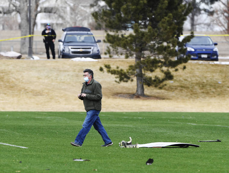 ASSOCIATED PRESS
                                A man walks past airplane parts scattered on a soccer field at Broomfield Commons Park on Saturday in Broomfield, Colo. Debris from a United Airlines plane fell onto Denver suburbs during an emergency landing Saturday after one of its engines suffered a catastrophic failure and rained pieces of the engine casing on a neighborhood where it narrowly missed a home.