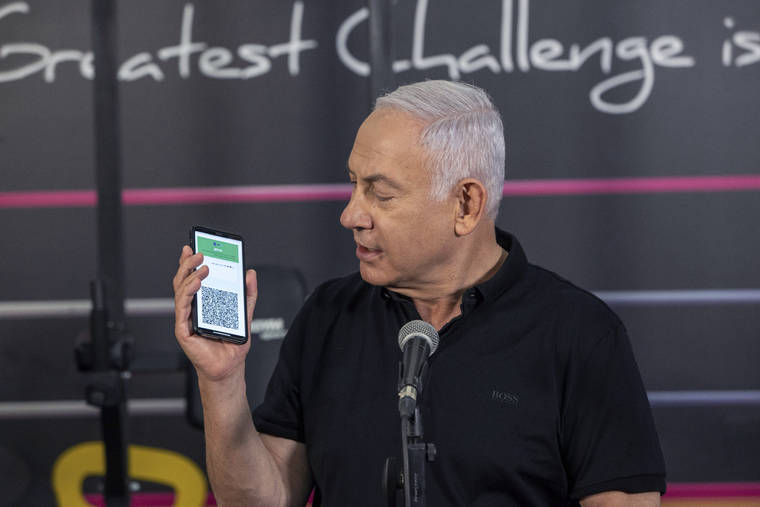 ASSOCIATED PRESS
                                Israeli Prime Minister Benjamin Netanyahu talks to the media during a visit to the Fitness gym ahead of the re-opening of the branch in Petah Tikva, Israel, on Saturday.