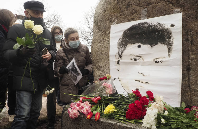 Russians lay flowers to mark the assassination of the opposition leader