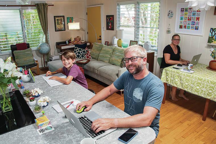CRAIG T. KOJIMA / CKOJIMA@STARADVERTISER.COM
                                The Ayers family, Laura and Mark with son, Rune, and daughter, Malea, have their own work areas inside their Kailua home.