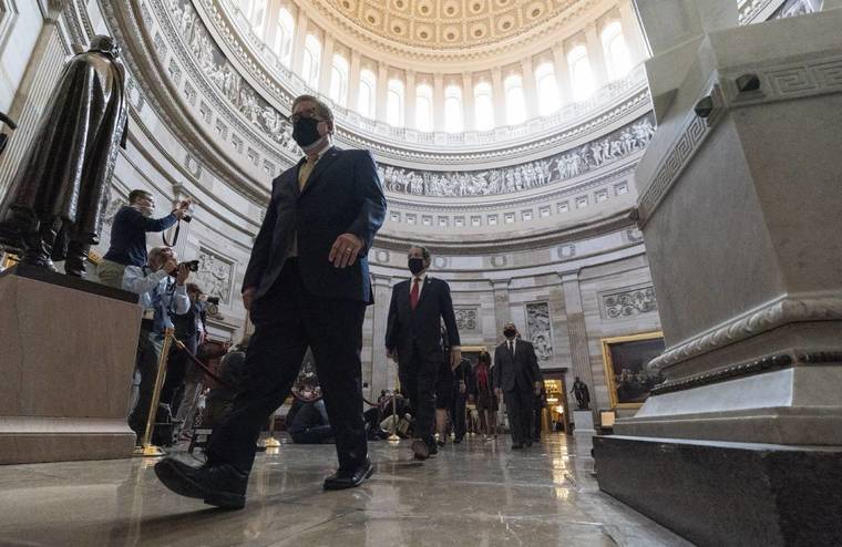 ASSOCIATED PRESS
                                Acting Sergeant at Arms Timothy Blodgett, left, lead Rep. Jamie Raskin, D-Md., second from left, the lead Democratic House impeachment manager, and other impeachment managers, through the Rotunda to the Senate for the second impeachment trial of former President Donald Trump, today, in Washington.