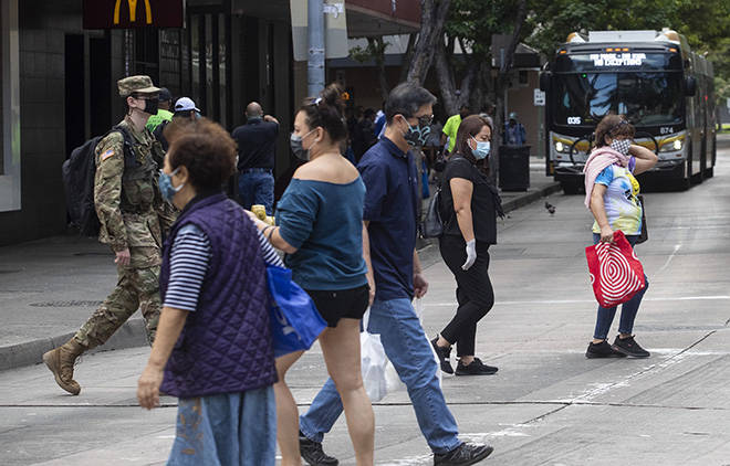 CINDY ELLEN RUSSELL / FEB. 4
                                Pedestrians wore masks as they crossed S. Hotel Street in downtown Honolulu earlier this month.