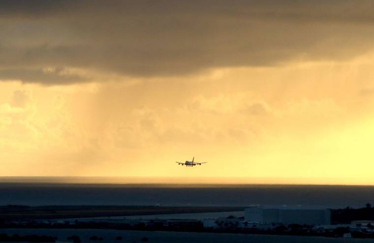 ASSOCIATED PRESS / APRIL 2020
                                A plane landed as the sun set over the Pacific Ocean in Honolulu. More than 200 people gathered on Kauai to show support for reopening tourism on the island amid the coronavirus pandemic.
