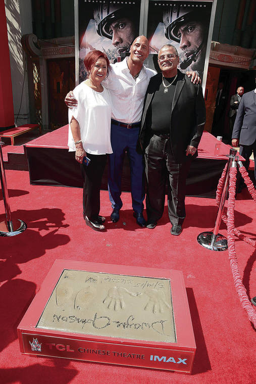 ASSOCIATED PRESS
                                Dwayne Johnson posed with his parents, Ata and Rocky Johnson, at his Hands and Footprints Ceremony in Hollywood in 2015.