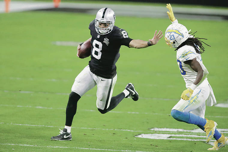 ASSOCIATED PRESS
                                Las Vegas Raiders quarterback Marcus Mariota ran for a gain against Los Angeles Chargers strong safety Rayshawn Jenkins in overtime in a 30-27 loss in Las Vegas last December.