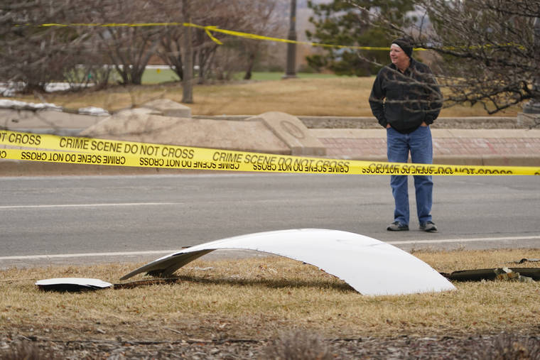 ASSOCIATED PRESS
                                A piece of debris from a passenger airplane is surrounded by police tape on a strip along Midway Boulevard in Broomfield, Colo., after the plane shed parts while making an emergency landing at nearby Denver International Airport.