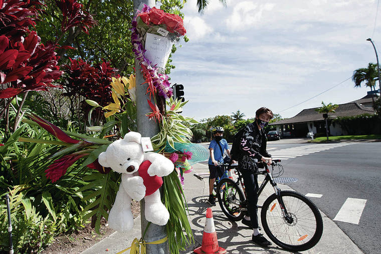 GEORGE F. LEE / GLEE@STARADVERTISER.COM
                                A memorial was started at the intersection of Hawaii Kai Drive and Hahaione Street on Wednesday for Parker John Trantham, the stabbing victim killed there on Tuesday morning.