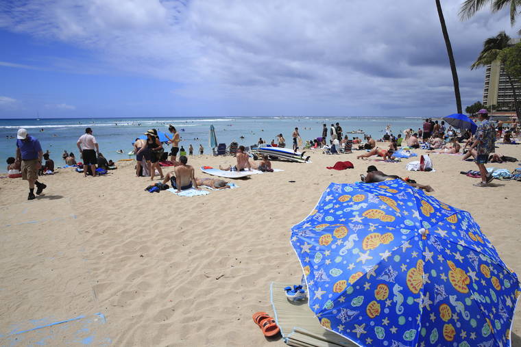 JAMM AQUINO / MARCH 29
                                Beachgoers are seen on the sand and in the ocean on Monday in Waikiki.
