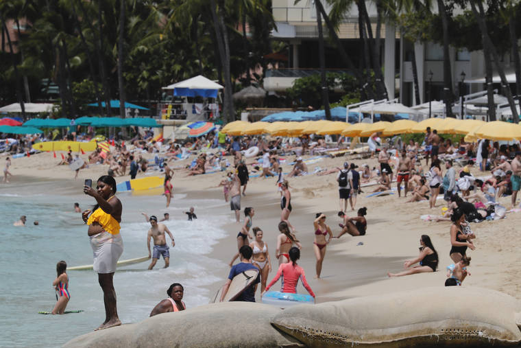 JAMM AQUINO / MARCH 29
                                Beachgoers are seen enjoying the sun, sand and surf on Monday in Waikiki. A total of 19,491 people arrived in Hawaii from outside the state, according to the latest data available from the Hawaii Tourism Authority.