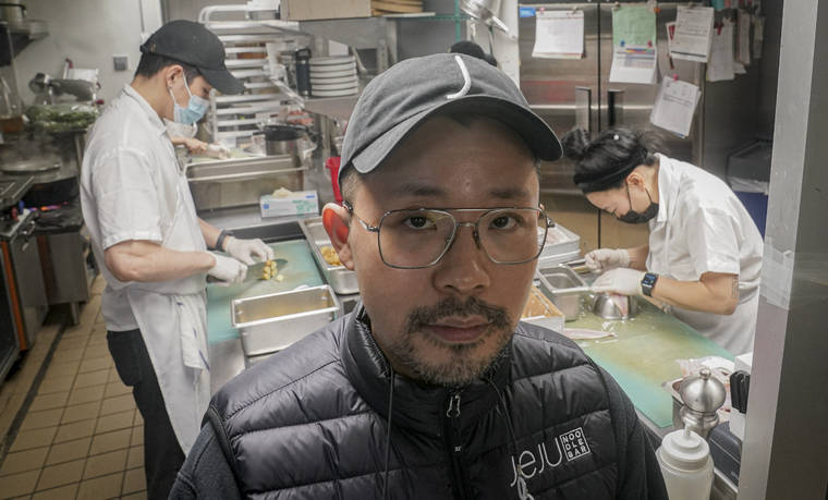 ASSOCIATED PRESS
                                Korean American chef Douglas Kim, center, owner of the restaurant Jeju, which was vandalized during last year’s racial injustice protests, is shown in the kitchen as food is being prepped, Feb. 13, in New York. Asian Americans have been facing a dangerous climate since the coronavirus entered the U.S. a year ago.