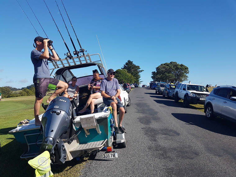 ASSOCIATED PRESS
                                John Fitzgerald, left, on holidays with his wife Rita and friends, scans the horizon from high ground for any sign of a tsunami near Waitangi, New Zealand, Friday.