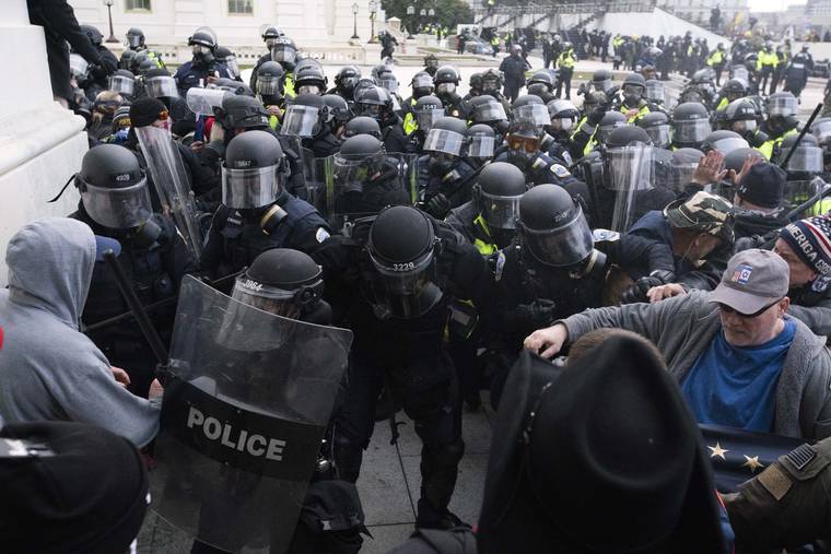 ASSOCIATED PRESS
                                U.S. Capitol Police pushed back rioters trying to enter the U.S. Capitol, Jan. 6, in Washington. A former State Department aide in President Donald Trump’s administration has been charged with participating in the deadly siege at the Capitol.