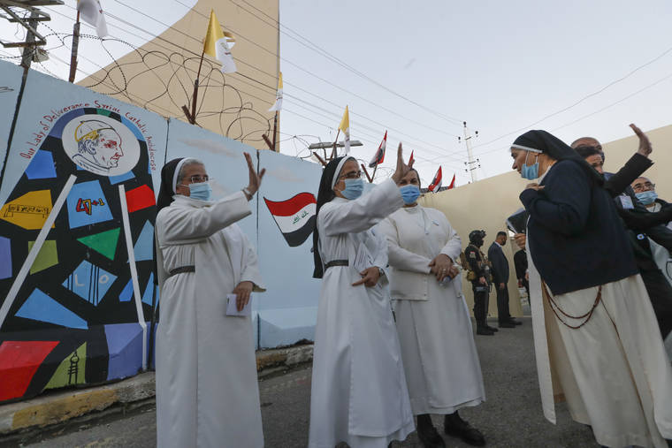 ASSOCIATED PRESS
                                Nuns waves as Pope Francis leaves the Sayidat al-Nejat (Our Lady of Salvation) Cathedral, in Baghdad, Iraq, Friday.