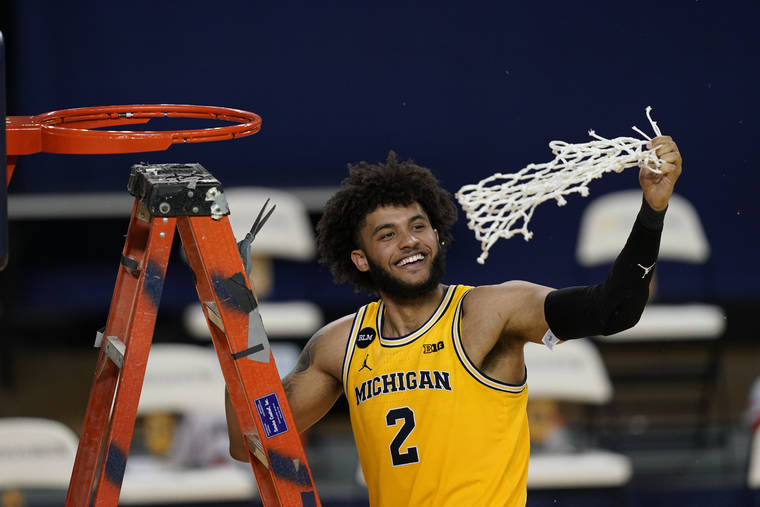ASSOCIATED PRESS
                                Michigan forward Isaiah Livers twirls the net after the team won the Big Ten title against Michigan State on March 4.
