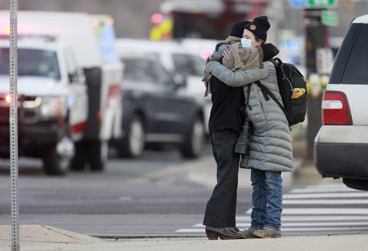 ASSOCIATED PRESS
                                Women hug on the corner of Broadway and Table Mesa Drive near a King Soopers grocery store where a shooting with multiple fatalities happened today in Boulder, Colo.