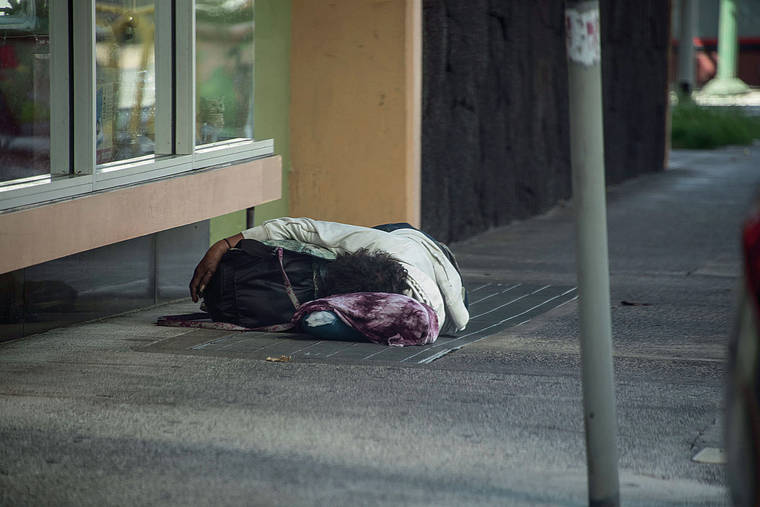 STAR-ADVERTISER / 2020
                                A homeless man slept on Nuuanu Avenue in Chinatown.