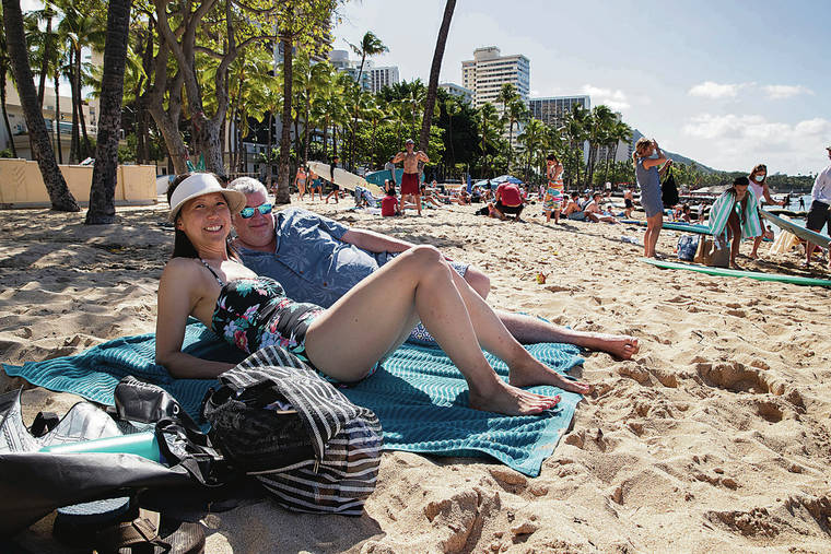 CINDY ELLEN RUSSELL / CRUSSELL@STARADVERTISER.COM
                                Ivanna Park and Brad Spencer enjoyed the beach on Friday. Park, a repeat visitor from Bloomington, Ind., said she feels Waikiki is safe.