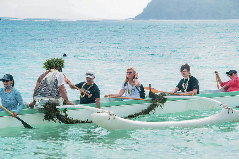 CRAIG T. KOJIMA / CKOJIMA@STARADVERTISER.COM
                                The group paddled out on a canoe to mark Nicholas’ 21st birthday.
